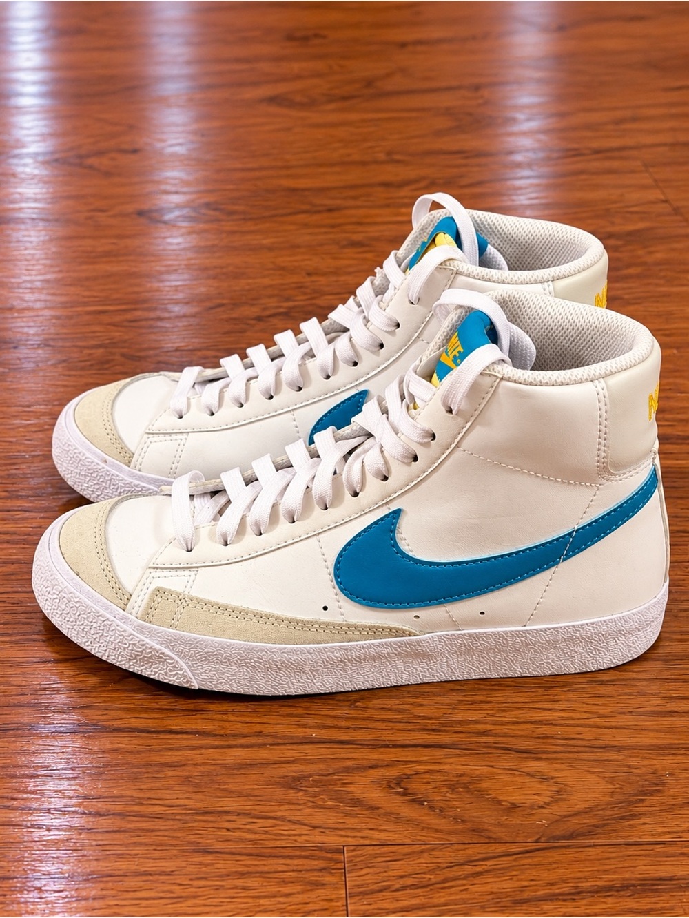 Nike White High-Top Sneakers with Blue Swoosh